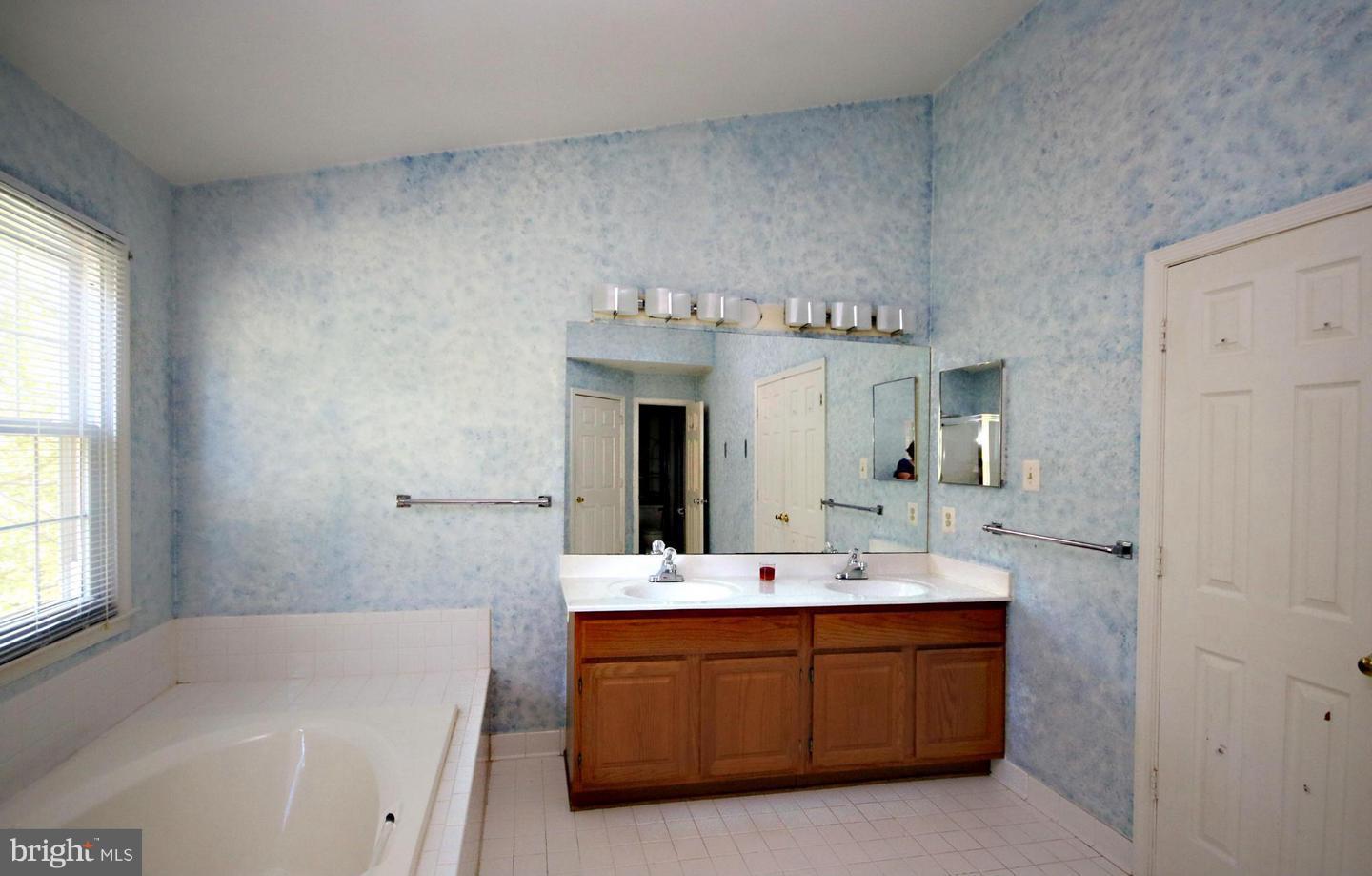 14416 Old Stage Road Bowie, MD 20720 - Photo 18 of 24 a bathroom with a sink double vanity and a mirror