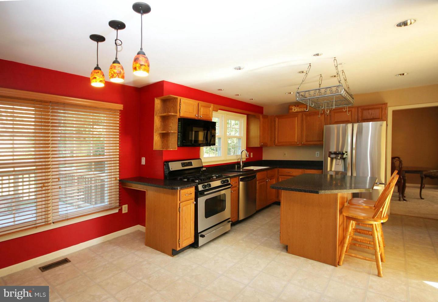 14416 Old Stage Road Bowie, MD 20720 - Photo 5 of 24 a kitchen with stainless steel appliances granite countertop a stove and a sink