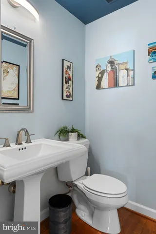 a bathroom with a toilet a sink and mirror