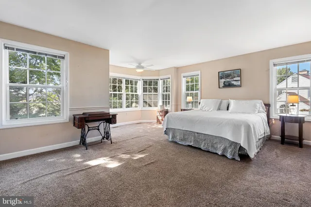 a spacious bedroom with a bed and a window