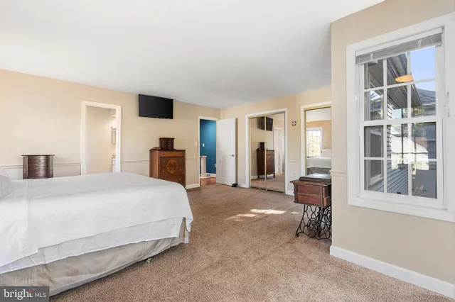 a bedroom with a large bed and a large window