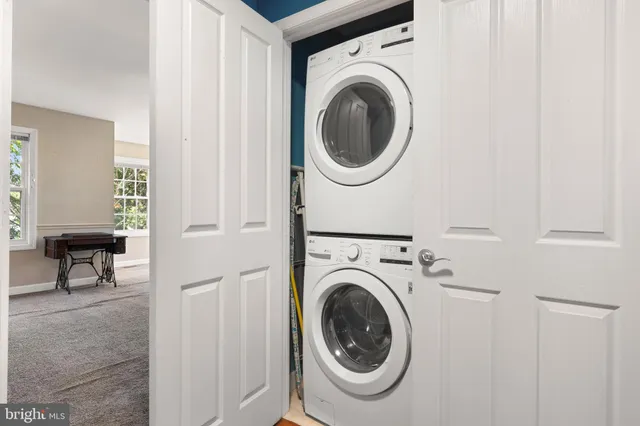 a view of a hallway with washer and dryer
