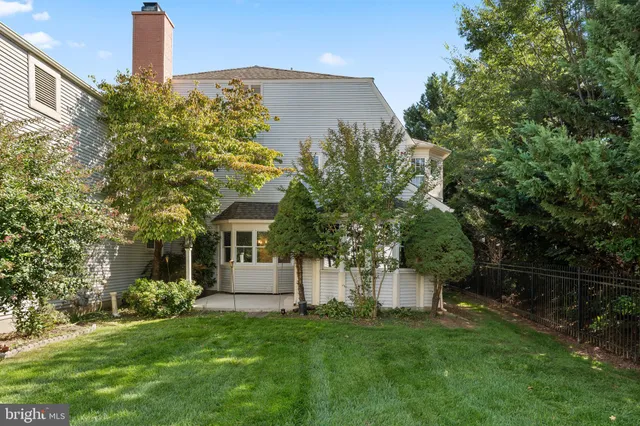 a front view of a house with a garden and plants