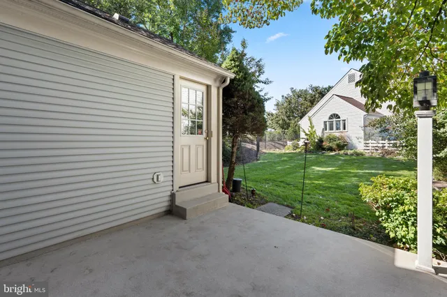 a view of a house with a yard and potted plants
