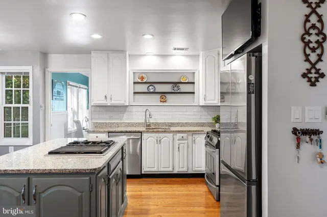 a kitchen with a sink stove and refrigerator