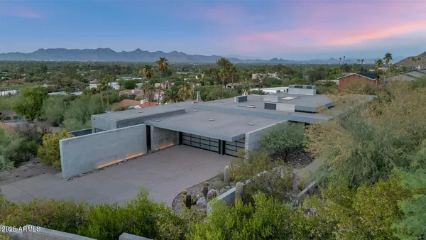 an aerial view of a house with a yard and lake view