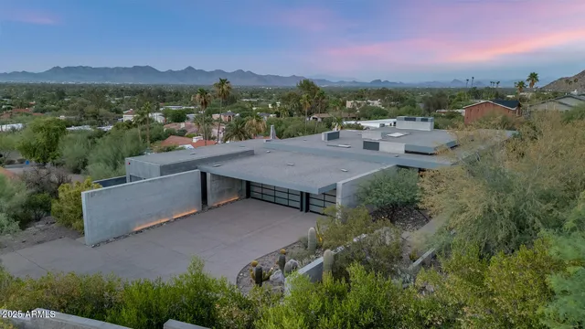 an aerial view of a house with a yard and lake view