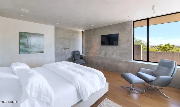 a bedroom with a bed and a large window