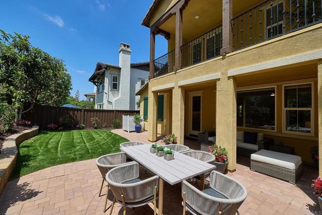 a view of a patio with table and chairs and potted plants