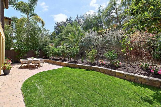 a view of a backyard with sitting area