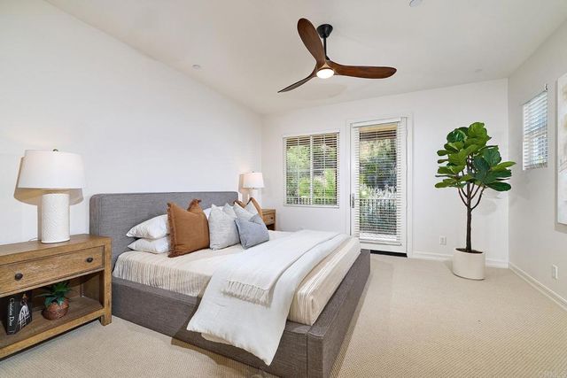 a bed room with a bed and a potted plant