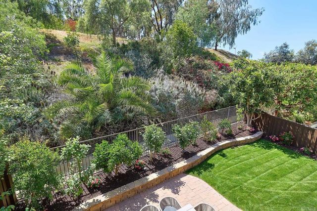 a bedroom with a large bed and a chandelier fan