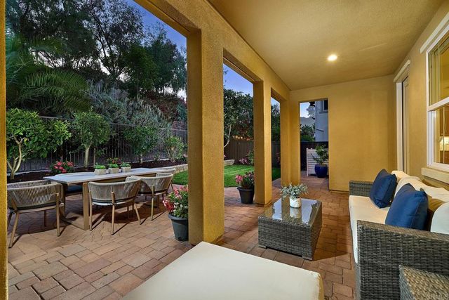a view of a chairs and table in backyard of the house