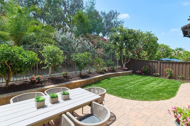 a view of backyard with swimming pool and outdoor seating