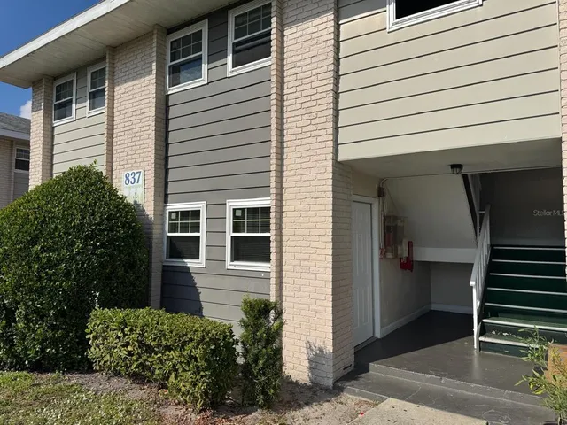 a view of a house with a door and wooden walls