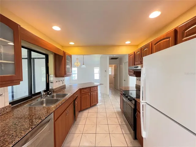 a bedroom with a bed and a chandelier fan