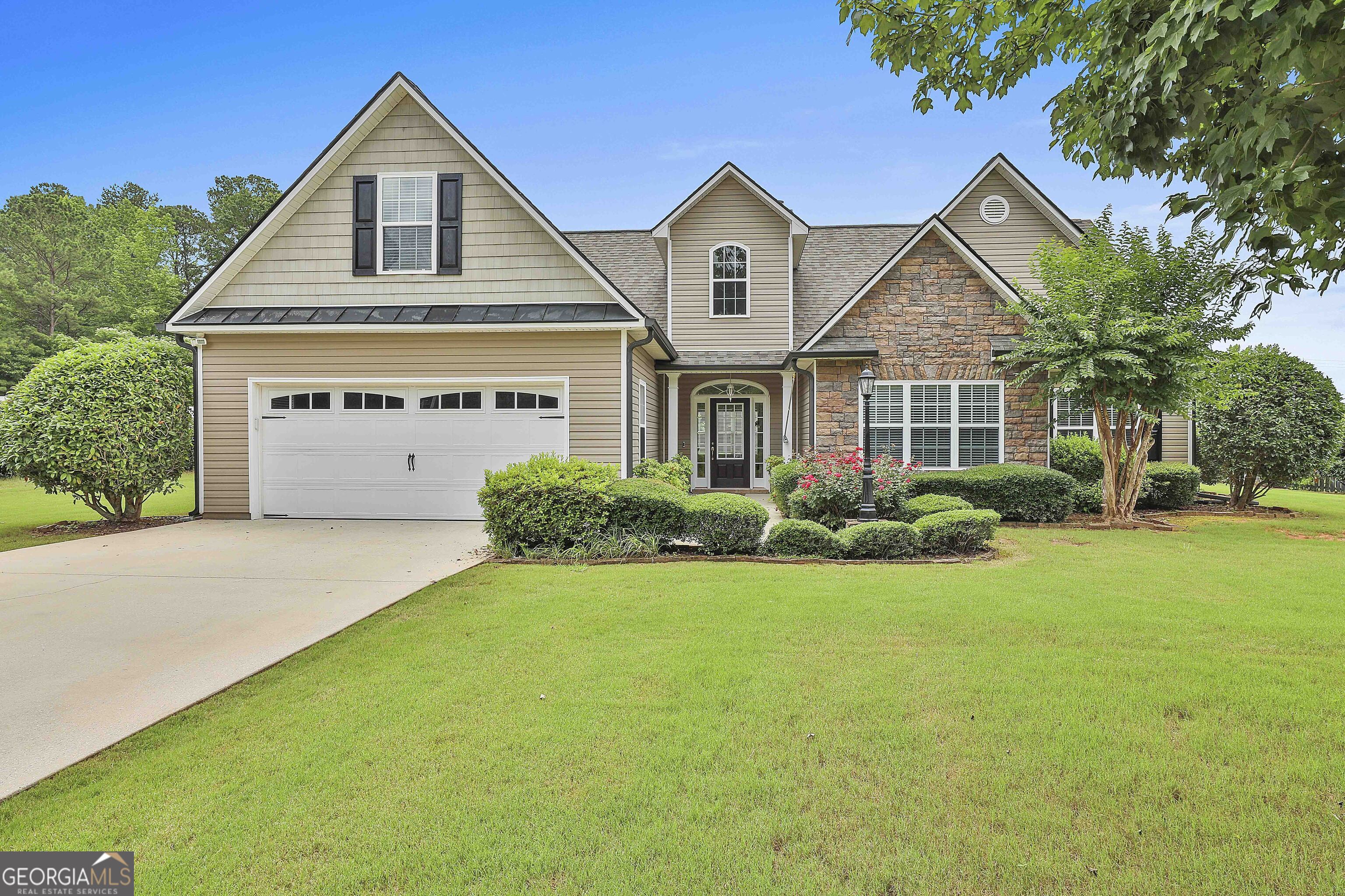 a front view of a house with a yard and garage