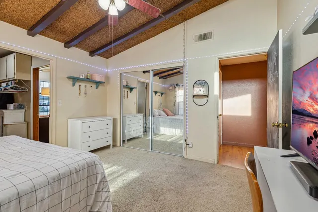 a bedroom with a bed and a flat tv screen