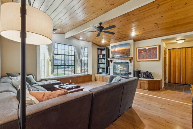a living room with fireplace furniture and a flat screen tv