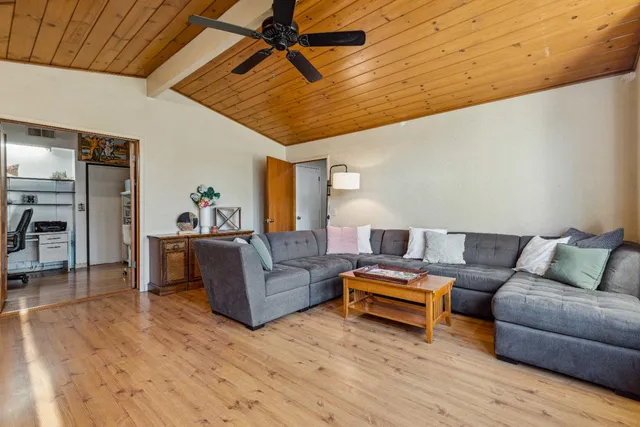 a living room with furniture and wooden floor