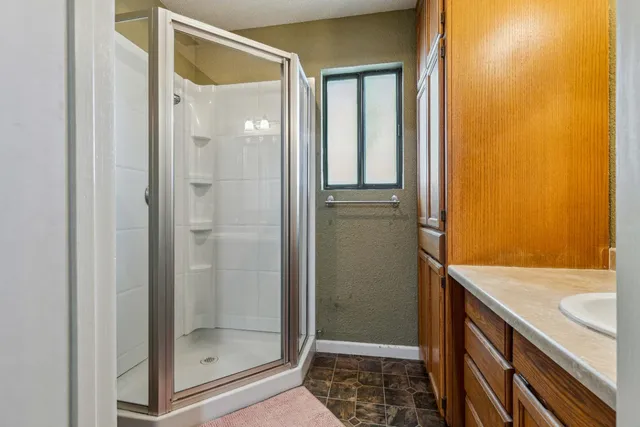 a bathroom with a shower and a sink
