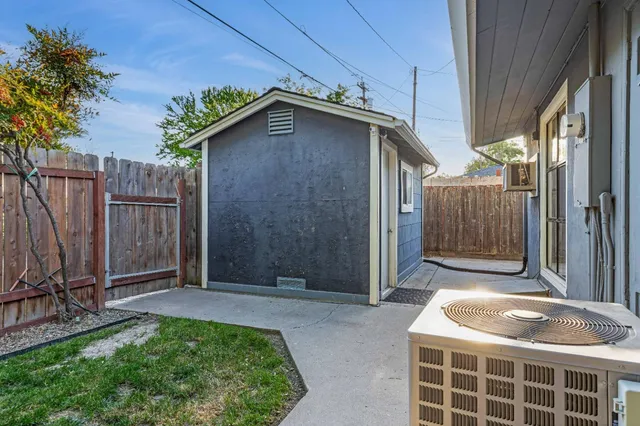 a backyard of a house with table and chairs