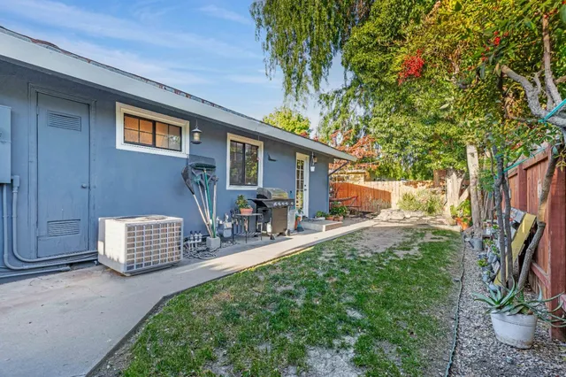 a backyard of a house with yard and outdoor seating