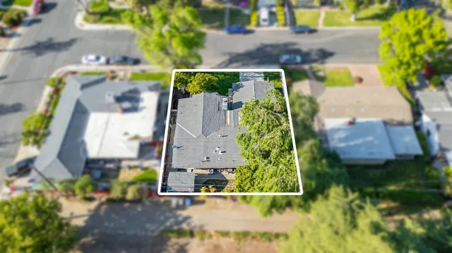 an aerial view of a house with a yard