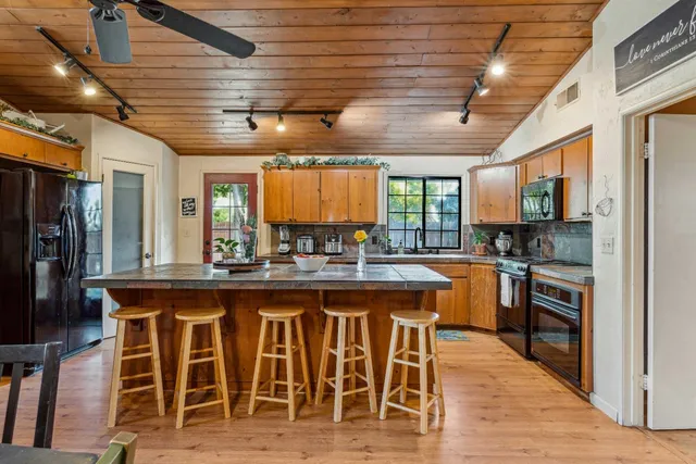 a large kitchen with a table and chairs in it