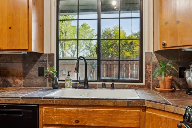 a kitchen with sink and window