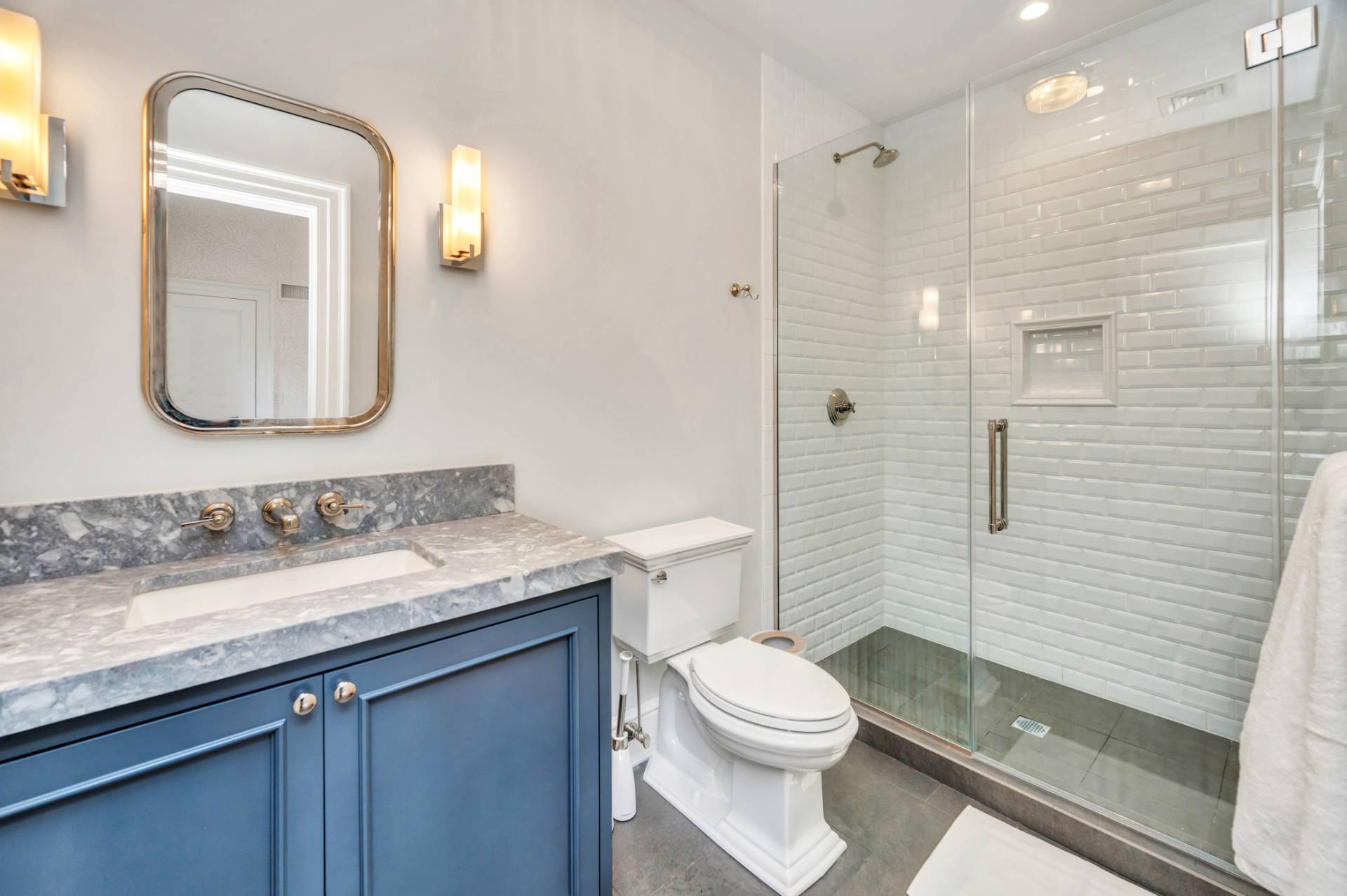 21 Barn Lane Bridgehampton, NY 11932 - Photo 1 of 1 a bathroom with a granite countertop sink a toilet and shower