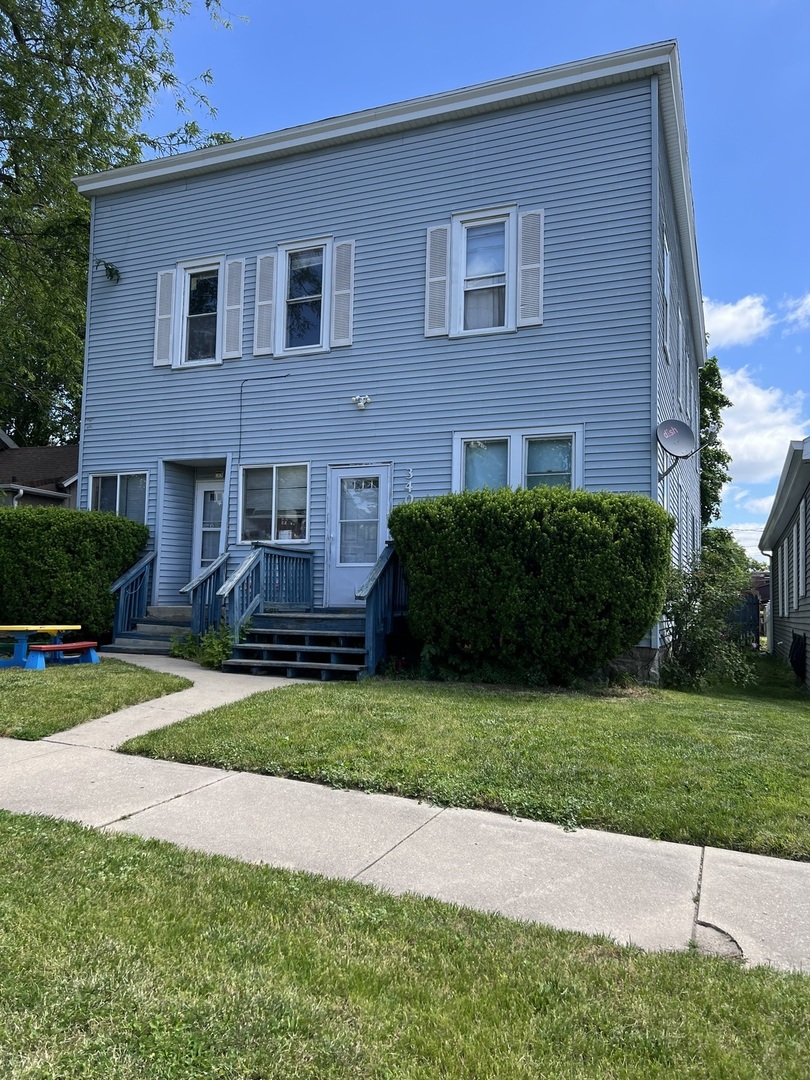a view of a house with a yard and plants