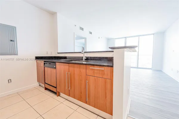 a kitchen with stainless steel appliances a refrigerator and a stove top oven