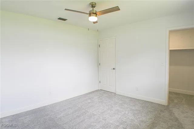 a bathroom with a granite countertop toilet sink and mirror