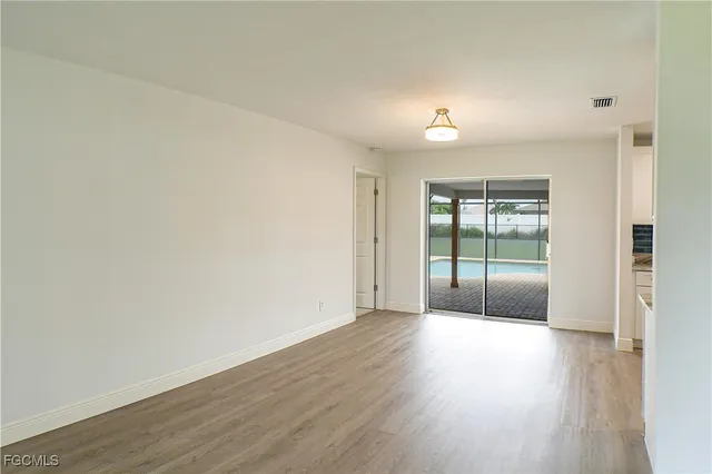 wooden floor in an empty room with a window
