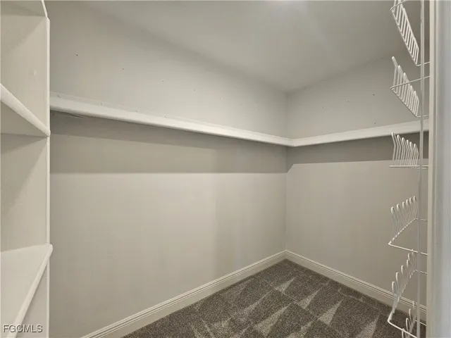 a bathroom with a granite countertop sink toilet and mirror
