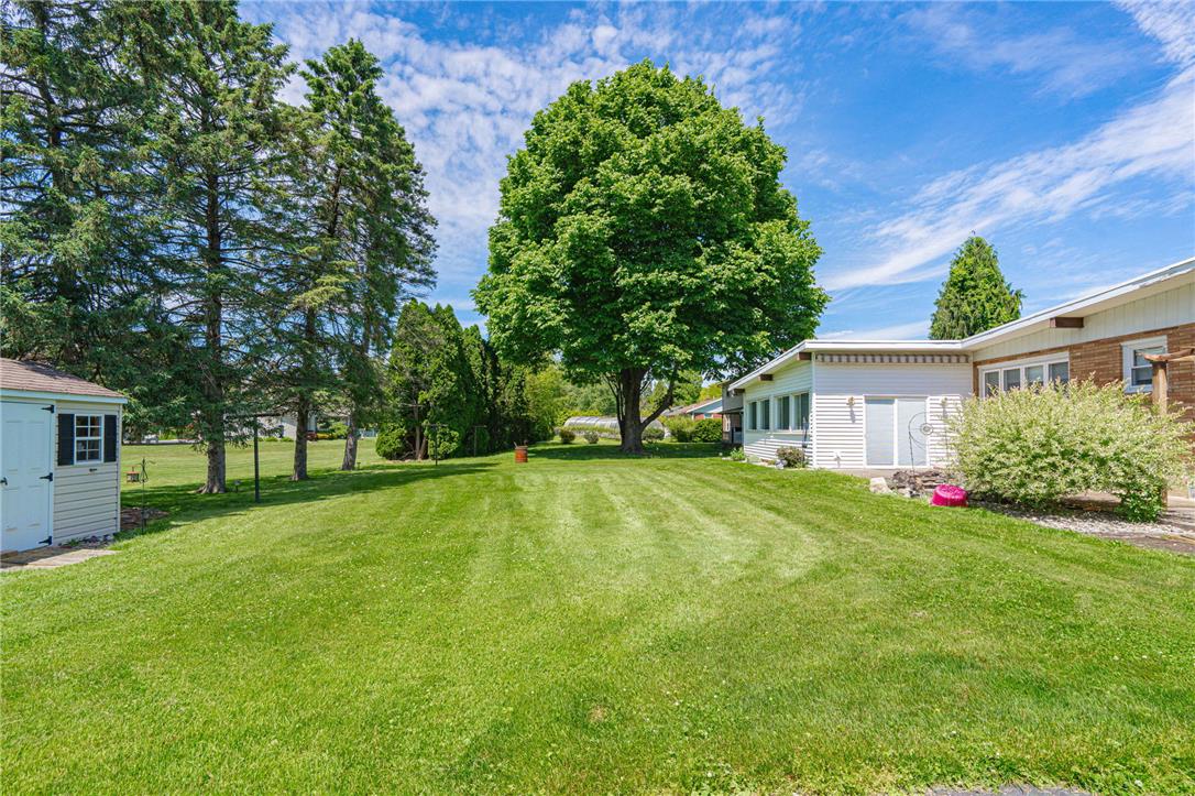 579 Cherry Road Northampton, PA 18067 - Photo 50 of 57 A vast, verdant lawn extends toward the residence, bordered by mature trees providing ample shade.
