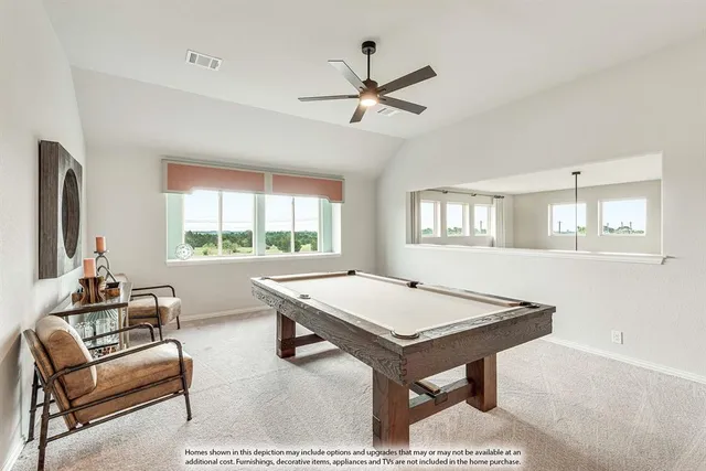 a room with pool table and windows
