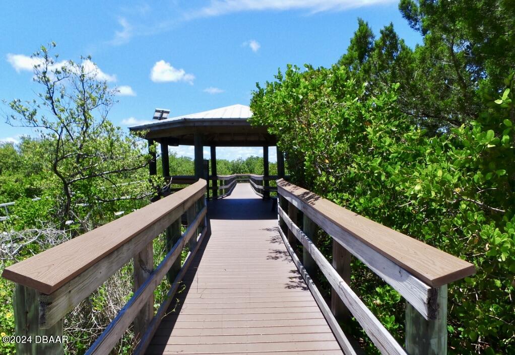 4714 Montrose Avenue Ponce Inlet, FL 32127 - Photo 7 of 9 a balcony with wooden floor and outdoor space