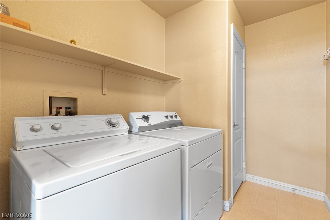 8934 Deep Ridge Court Las Vegas, NV 89178 - Photo 20 of 47 Functional laundry space featuring a practical shelf for organization.