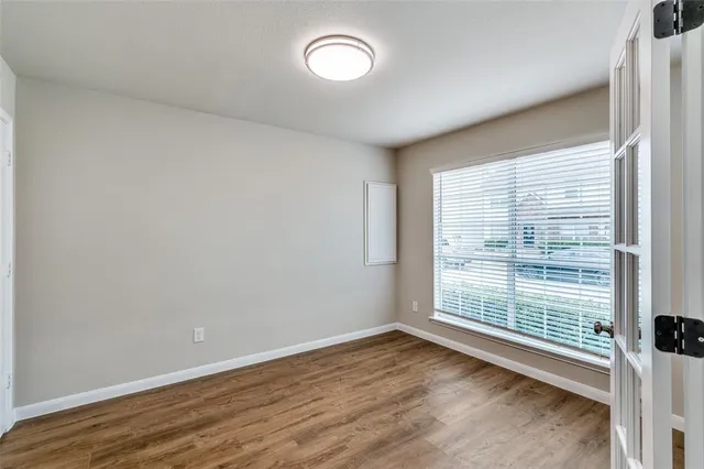 a dining room with furniture and wooden floor