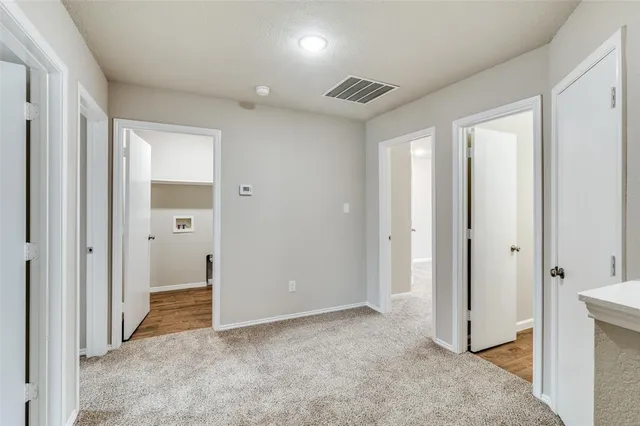 an empty room with wooden floor and closet