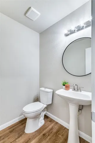 a bathroom with a sink toilet and a mirror