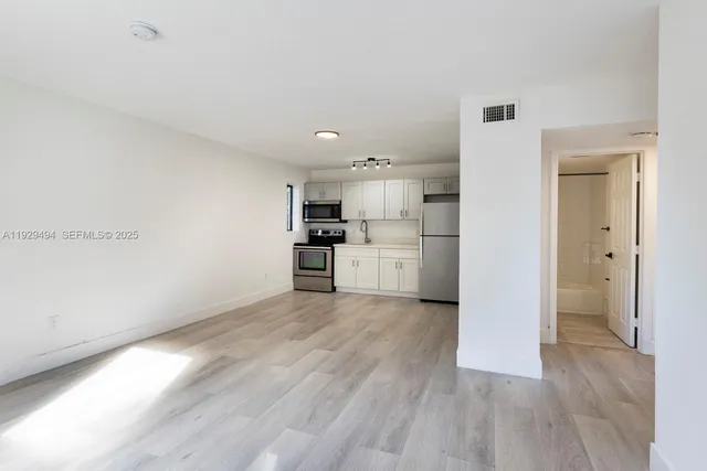 a view of kitchen with wooden floor