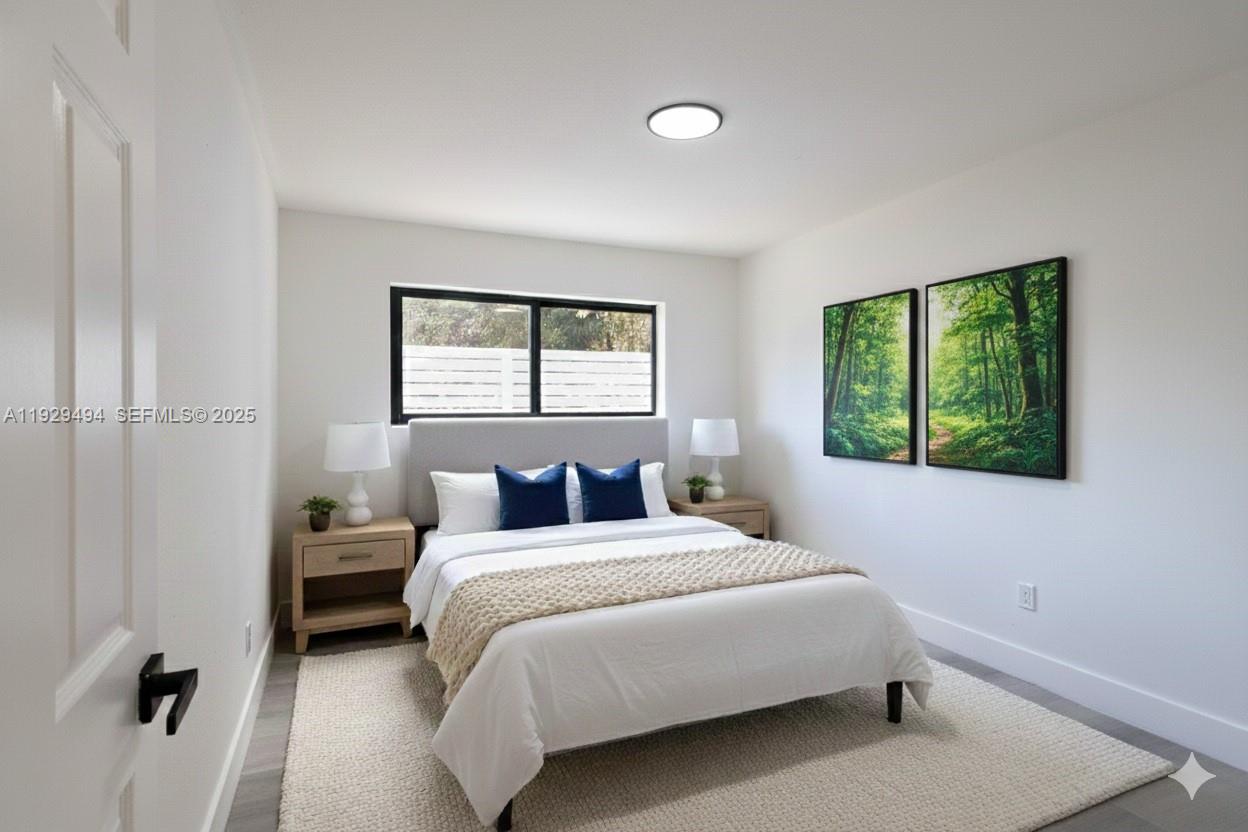 37 Northwest 59th Street, Unit 1 Miami, FL 33127 - Photo 8 of 13 a bedroom with a bed and a window
