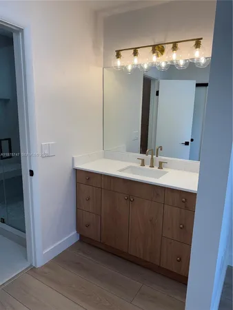 a bathroom with a double vanity sink and a mirror