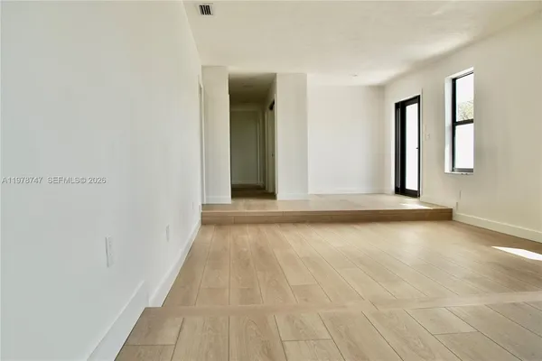 a view of a livingroom with an empty space and window