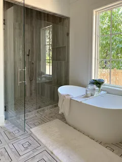 a bathroom with a bathtub and shower