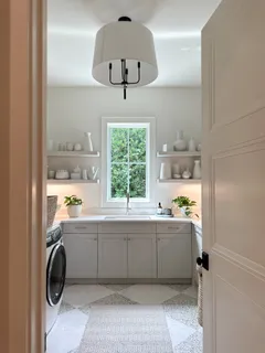 a room with a window a washer and dryer