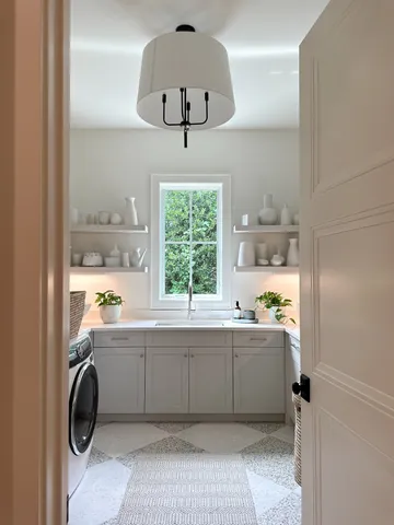 a room with a window a washer and dryer